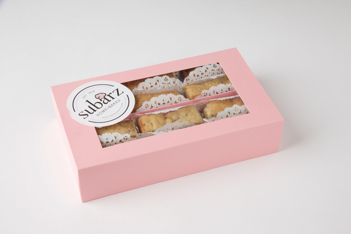A Stylish Pink Gift Box from Subarzsweets showcasing their Gluten-Free Spiced Fig Subarz. The box's clear window gives a sneak peek of nine Subarz, each carefully nestled in a delicate white paper liner. Makes a memorable corporate gift, available for online order with nationwide delivery.